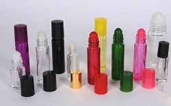 Glass Roll-ons in flint, red, blue, green, yellow, and black. Additional Personal Care Containers with a variety of sprayers and applicator caps.